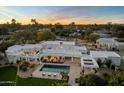 Stunning aerial view of modern white home highlighting the pool and landscaped backyard at sunset at 6039 E Laurel Ln, Scottsdale, AZ 85254