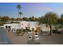 Striking modern home with clean lines, desert landscaping, and a welcoming walkway at 6039 E Laurel Ln, Scottsdale, AZ 85254