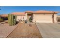 Single-story home with desert landscaping, two-car garage, and a welcoming front porch at 6331 S Cypress Point Dr, Chandler, AZ 85249