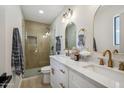 Spa-like bathroom with double vanity, walk-in shower, and gold fixtures at 7343 E Villa Way, Scottsdale, AZ 85257