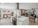 Open concept kitchen and living area with island and modern fireplace at 7343 E Villa Way, Scottsdale, AZ 85257