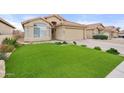 Landscaped front yard with artificial turf and desert landscaping at 7365 E Adele Ct, Scottsdale, AZ 85255