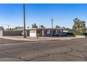 A charming single-story home featuring a carport and minimalist landscaping, with great curb appeal at 7743 E Roosevelt St, Scottsdale, AZ 85257