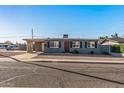 Inviting single-story home with a gravel front yard, covered carport, and well-maintained facade at 7743 E Roosevelt St, Scottsdale, AZ 85257