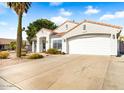 White stucco house with a two-car garage and a nicely landscaped yard at 7908 W Rose Garden Ln, Peoria, AZ 85382