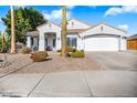 House with a white two-car garage and drought-tolerant landscaping at 7908 W Rose Garden Ln, Peoria, AZ 85382