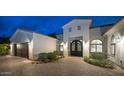 Elegant home exterior with a grand entrance and landscaping at 8519 E Regina Cir, Mesa, AZ 85207