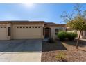 House exterior with two-car garage and desert landscaping at 10960 E Monte Ave # 223, Mesa, AZ 85209