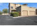 Two-story home with two-car garage, landscaping, and a patio umbrella at 11022 N Indigo Dr # 121, Fountain Hills, AZ 85268