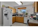 Galley-style kitchen with refrigerator, stove, and ample counter space at 1272 E Dust Devil Dr, San Tan Valley, AZ 85143