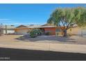 Brick ranch house with a two-car garage and nicely landscaped front yard at 13226 W Mesa Verde Dr, Sun City West, AZ 85375