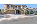 Two-story house with a three-car garage and desert landscaping at 13611 W Merrell St, Avondale, AZ 85392