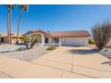 Single story home with desert landscaping and a two car garage at 14103 W Casa Linda Dr, Sun City West, AZ 85375