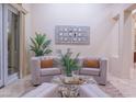 Cozy living area with neutral palette, stylish seating, and sliding glass doors that enhance natural light at 15701 E Greystone Dr, Fountain Hills, AZ 85268