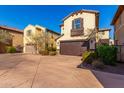 Three-story tan house with a brown garage door and walkway at 15913 S 11Th Way, Phoenix, AZ 85048