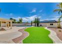 Landscaped backyard with a pool and artificial turf at 16414 N 48Th Way, Scottsdale, AZ 85254