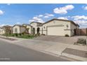 Beautiful single Gathering home featuring manicured front yard and three-car garage at 20456 E Camina Buena Vis, Queen Creek, AZ 85142