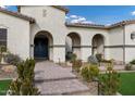 Inviting front entrance featuring a set of columns and a stone walkway and planters at 20456 E Camina Buena Vis, Queen Creek, AZ 85142