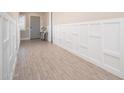 Elegant hallway with wood-look tile floors and custom wainscoting at 23448 N 76Th Pl, Scottsdale, AZ 85255