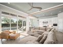 Open-concept living room with large sliding glass doors and ceiling fan at 23448 N 76Th Pl, Scottsdale, AZ 85255