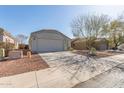 Front view of a single-story house with a driveway and landscaping at 23625 N El Frio Ct, Sun City, AZ 85373