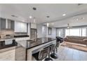 Open concept kitchen features granite island and stainless steel appliances at 2641 W Wethersfield Rd, Phoenix, AZ 85029