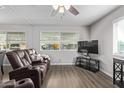 Living room with brown leather recliners and a large TV at 2650 W Union Hills Dr # 108, Phoenix, AZ 85027