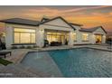 Relaxing backyard oasis with a refreshing pool, covered patio, and outdoor dining area at 2752 E Pelican Ct, Gilbert, AZ 85297