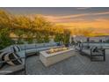 Inviting outdoor living space featuring a cozy fire pit, comfortable seating, and lush greenery at 2752 E Pelican Ct, Gilbert, AZ 85297