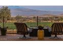 Patio furniture with fire pit overlooking a golf course and mountains at 29215 N Horton Creek Trl, Rio Verde, AZ 85263