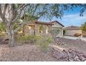 A charming house with stone exterior, a gated entry, and mature landscaping at 29762 N 69Th Ln, Peoria, AZ 85383