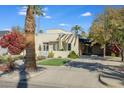 House exterior showcasing a large front yard with mature palm trees at 320 W Cypress St, Phoenix, AZ 85003