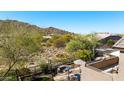 Scenic backyard view from the balcony, showcasing the desert landscape and outdoor fire pit seating at 3652 N Sonoran Hts, Mesa, AZ 85207