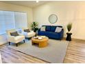 Bright and airy living room featuring a comfy sofa and two armchairs at 3743 W Shannon St, Chandler, AZ 85226