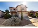 Two-story house with a two-car garage and desert landscaping at 4849 E Abraham Ln, Phoenix, AZ 85054