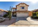 Two-story house with a two-car garage and desert landscaping at 4849 E Abraham Ln, Phoenix, AZ 85054