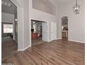 Bright living room featuring hardwood floors, neutral walls, and entry to additional rooms at 5184 W Del Rio St, Chandler, AZ 85226