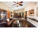 Open dining room with hardwood floors and a large wood table at 5213 W Soft Wind Dr, Glendale, AZ 85310