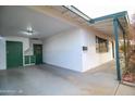 Attached carport with storage cabinets and door at 5720 E Cicero St, Mesa, AZ 85205