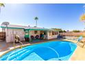 Stunning backyard pool, a covered patio, and lounge chairs creating the perfect outdoor oasis at 6058 E El Paso St, Mesa, AZ 85205