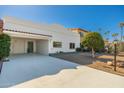 White single-story home with a carport and mature tree at 7663 E Coolidge St, Scottsdale, AZ 85251