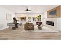 Bright living room featuring a fireplace and dining area at 7663 E Coolidge St, Scottsdale, AZ 85251