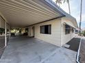 View of the exterior of a tan mobile home with carport at 8103 E Southern Ave # 84, Mesa, AZ 85209