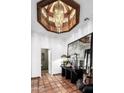 Stunning foyer with terra cotta tile, an ornate chandelier, and decorative furnishings at 8119 E Foothills Dr, Scottsdale, AZ 85255