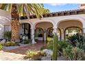 Inviting front entrance with arched walkways, desert landscaping and brick pavers at 8119 E Foothills Dr, Scottsdale, AZ 85255