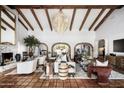 Spacious living room featuring exposed beams, brick archways, and stylish decor at 8119 E Foothills Dr, Scottsdale, AZ 85255