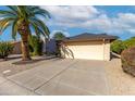 View of a single-story home with a two-car garage and nicely landscaped front yard at 814 S 78Th St, Mesa, AZ 85208