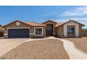 Single-story home with a two-car garage and well-maintained landscaping at 8773 W Pineveta Dr, Arizona City, AZ 85123