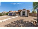 Single-story home with a two-car garage and a walkway leading to the entrance at 8773 W Pineveta Dr, Arizona City, AZ 85123