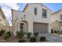 Two-story home featuring a two-car garage, a welcoming wreath on the front door, and lush landscaping at 10029 E Tahoe Ave, Mesa, AZ 85212